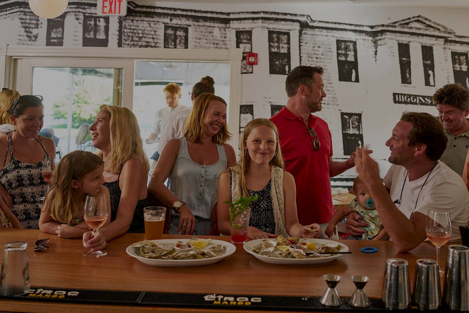 family eating oysters at the bar